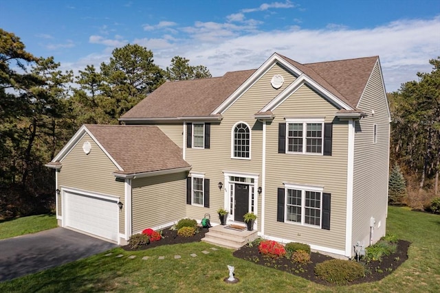 86 Pioneer Trl, Plymouth, MA 02360 - colonial home featuring a front yard, driveway, and a shingled roof