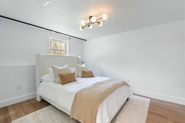 86 Pioneer Trl, Plymouth, MA 02360 - bedroom with wood finished floors, baseboards, and a chandelier