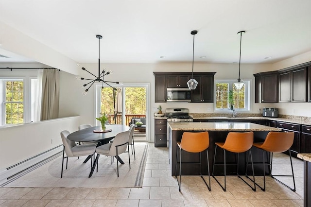 86 Pioneer Trl, Plymouth, MA 02360 - kitchen featuring stainless steel microwave, a chandelier, a center island, a kitchen bar, and light stone countertops