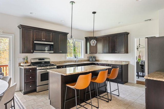 86 Pioneer Trl, Plymouth, MA 02360 - kitchen featuring stainless steel appliances, a sink, dark brown cabinetry, and hanging light fixtures