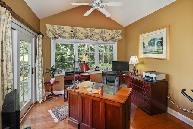 office space with ceiling fan, lofted ceiling, light wood-type flooring, and plenty of natural light