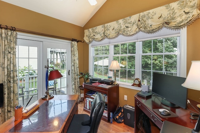 office with hardwood / wood-style flooring and vaulted ceiling