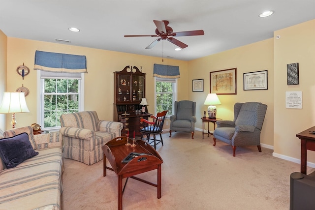 carpeted living room featuring ceiling fan and a healthy amount of sunlight