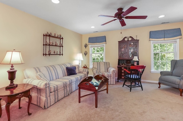 living room with a healthy amount of sunlight, light carpet, and ceiling fan