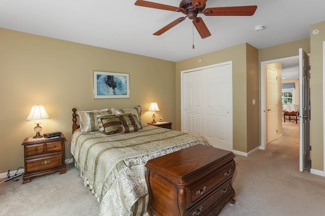 carpeted bedroom featuring ceiling fan and a closet