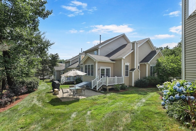 back of property featuring a yard and a patio