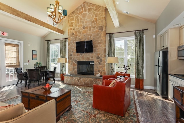 living room with a fireplace, beam ceiling, dark hardwood / wood-style floors, and plenty of natural light