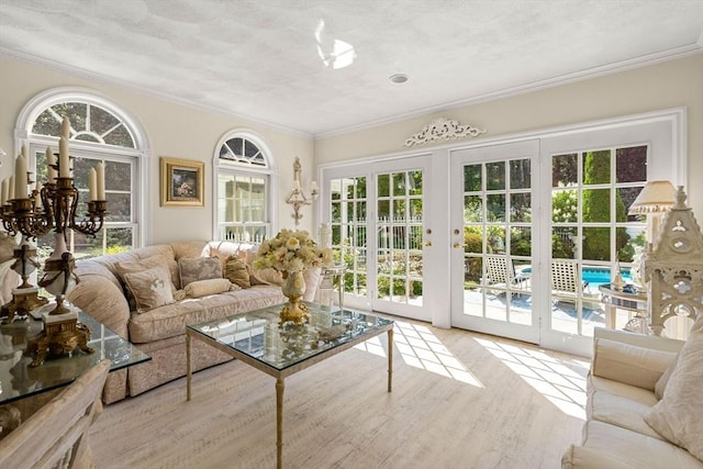 sunroom / solarium with french doors and a chandelier
