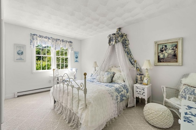 carpeted bedroom featuring baseboard heating and baseboards