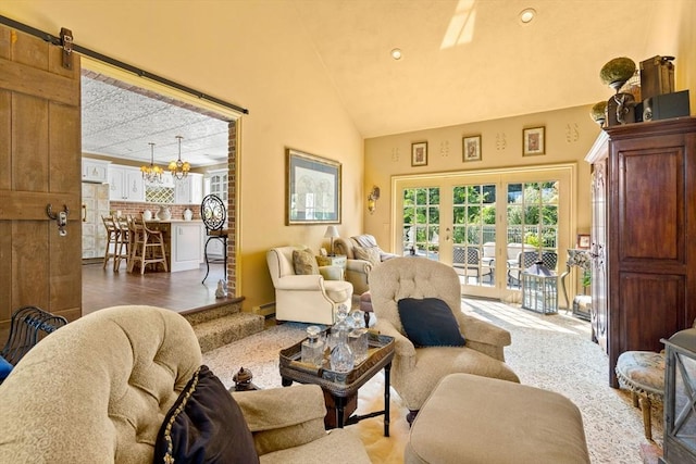living area featuring a chandelier, lofted ceiling, and a baseboard heating unit