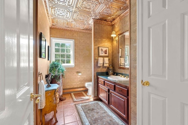 bathroom featuring an ornate ceiling, a baseboard radiator, toilet, and vanity