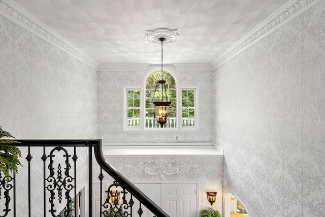 stairs featuring a chandelier