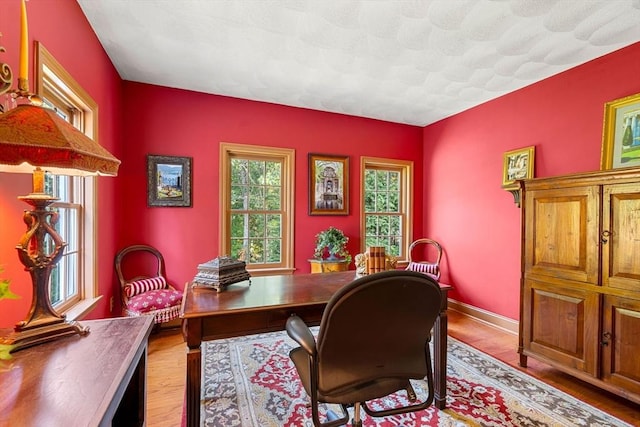 office space featuring wood finished floors and baseboards
