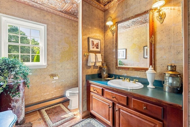 bathroom featuring a baseboard radiator, vanity, toilet, and tile patterned floors