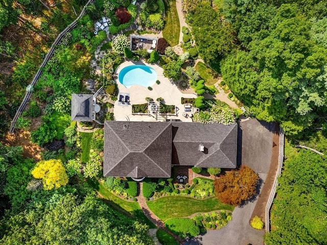 aerial view of property and surrounding area with a pool area