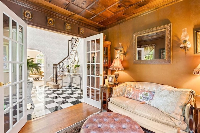 sitting room with wood ceiling, ornamental molding, and stairway