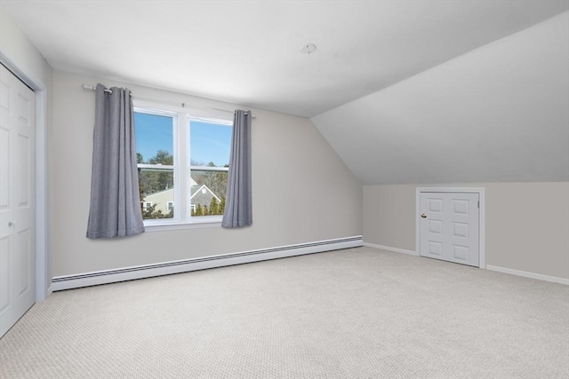 bonus room featuring vaulted ceiling, carpet flooring, baseboards, and a baseboard radiator