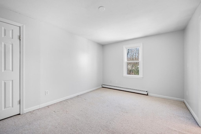 empty room featuring baseboards, a baseboard heating unit, and carpet