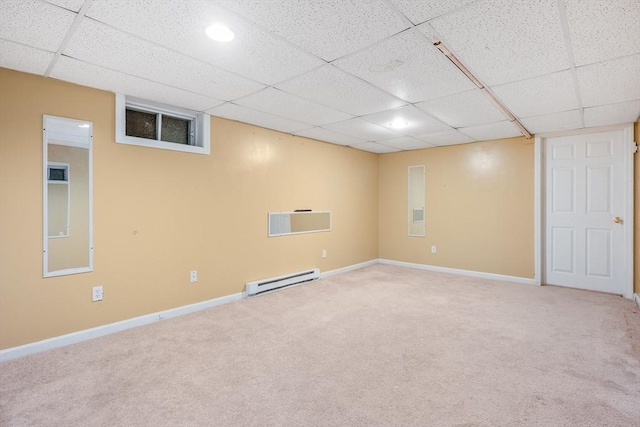 finished below grade area with carpet flooring, a baseboard heating unit, and baseboards