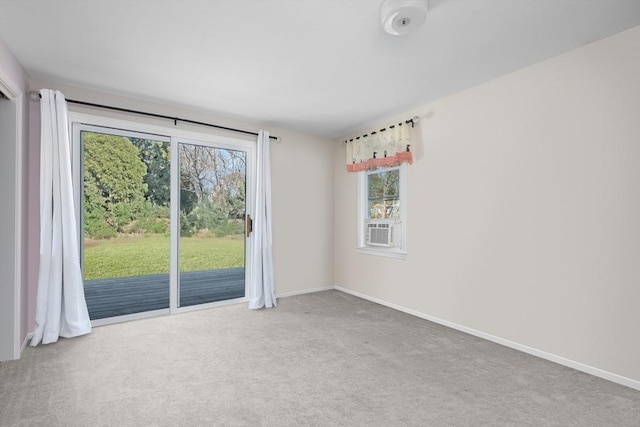 unfurnished room featuring cooling unit, baseboards, and carpet