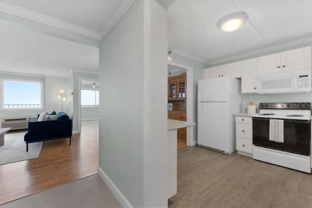 kitchen with white appliances, crown molding, light wood-style flooring, white cabinetry, and light countertops