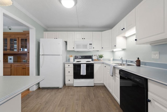kitchen featuring light wood-style flooring, white appliances, crown molding, light countertops, and white cabinets