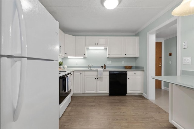 kitchen with light wood finished floors, a sink, white cabinetry, white appliances, and light countertops