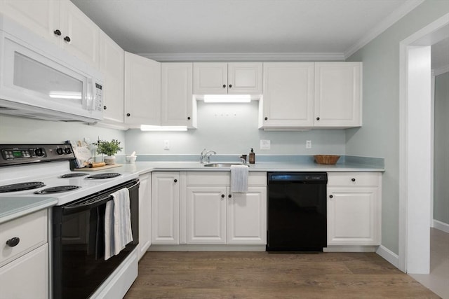 kitchen featuring range with electric cooktop, black dishwasher, white microwave, and white cabinets