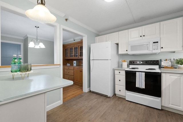 kitchen with white cabinets, light countertops, light wood finished floors, and white appliances