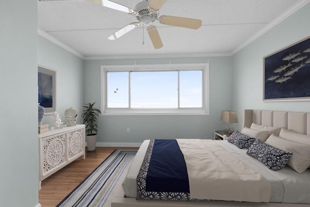 bedroom with crown molding, a textured ceiling, and wood finished floors