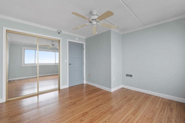 interior space featuring baseboards, light wood-style floors, visible vents, and ceiling fan