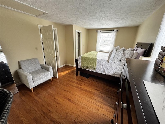 bedroom with hardwood / wood-style flooring and a textured ceiling