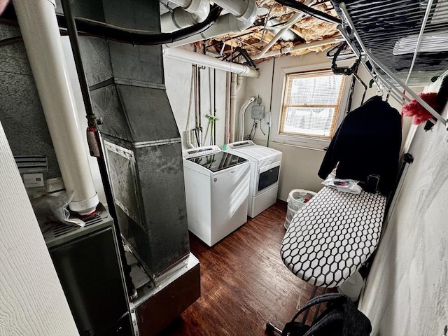 laundry room with independent washer and dryer and dark wood-type flooring