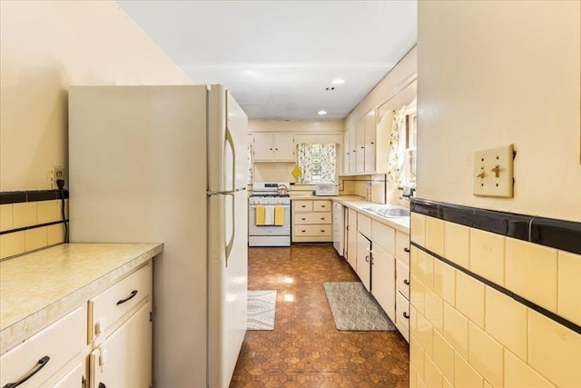 13 Conwell Ave, Somerville, MA 02144 - kitchen with white appliances, recessed lighting, light countertops, a sink, and backsplash