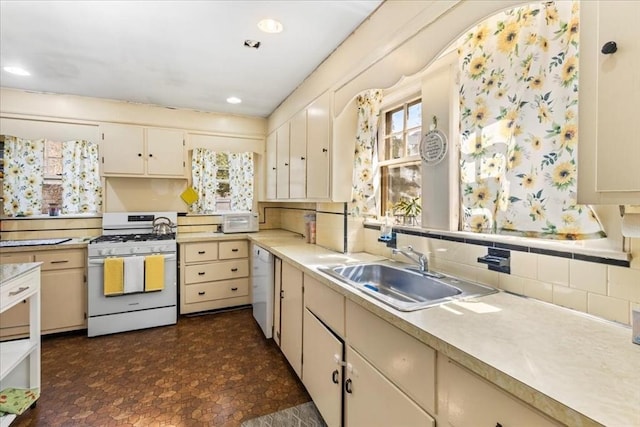13 Conwell Ave, Somerville, MA 02144 - kitchen with white appliances, decorative backsplash, a sink, and light countertops