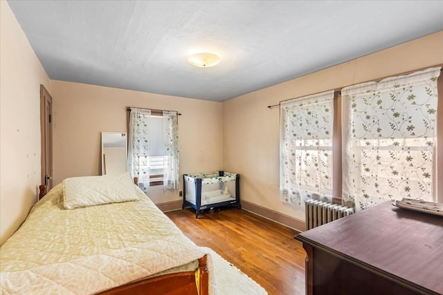 13 Conwell Ave, Somerville, MA 02144 - bedroom featuring baseboards, wood finished floors, and radiator