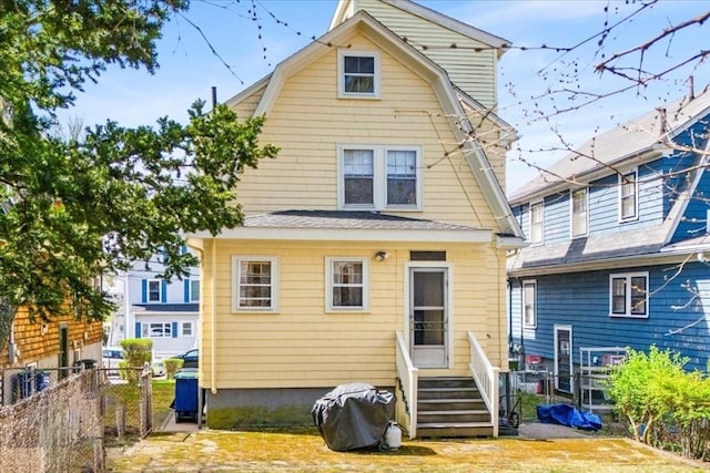 13 Conwell Ave, Somerville, MA 02144 - back of property with fence and a gambrel roof