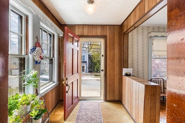 13 Conwell Ave, Somerville, MA 02144 - doorway featuring wallpapered walls, wood walls, and a wealth of natural light