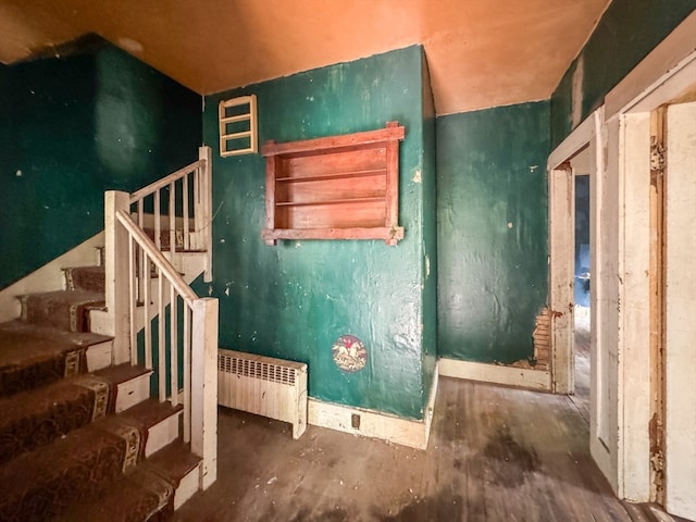 misc room featuring hardwood / wood-style flooring and radiator heating unit