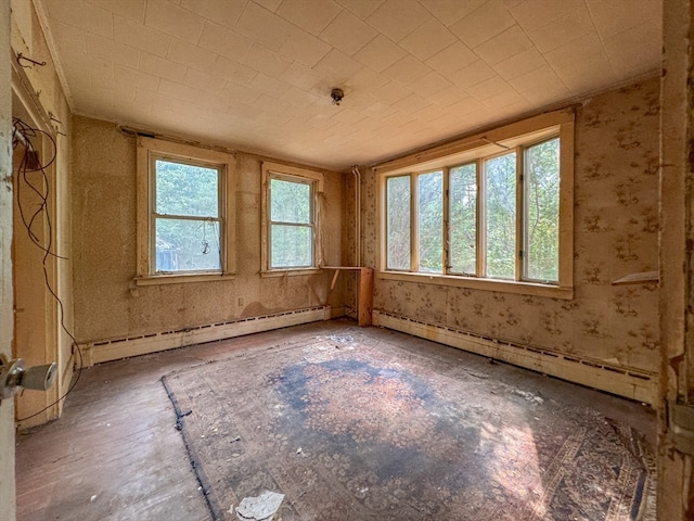 spare room with a baseboard radiator and a healthy amount of sunlight