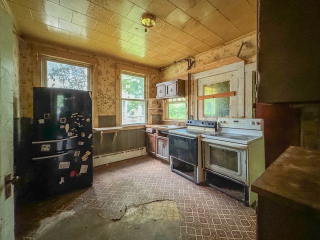 kitchen with white range with electric cooktop, a baseboard heating unit, washer / clothes dryer, and sink