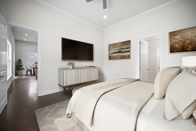 bedroom featuring crown molding, dark hardwood / wood-style floors, and ceiling fan