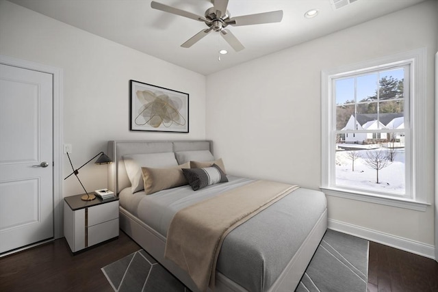 bedroom featuring ceiling fan and dark hardwood / wood-style floors