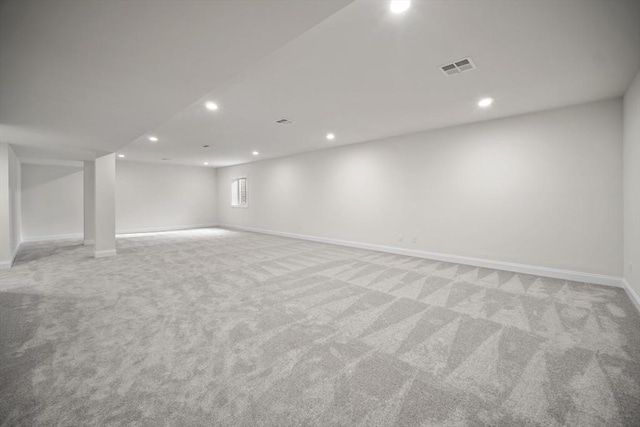 basement featuring light carpet