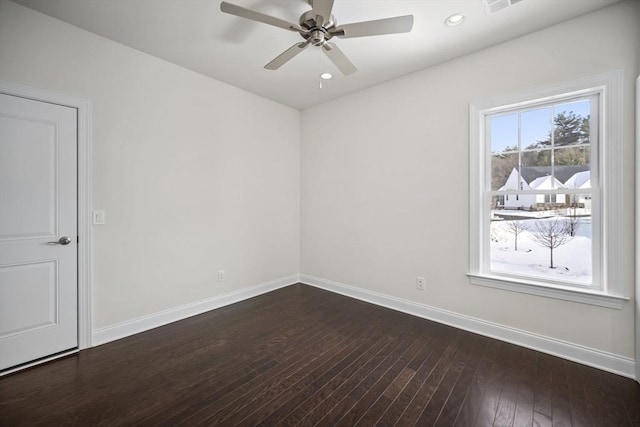 spare room with ceiling fan and dark hardwood / wood-style flooring