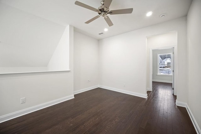 empty room with dark wood-type flooring and ceiling fan