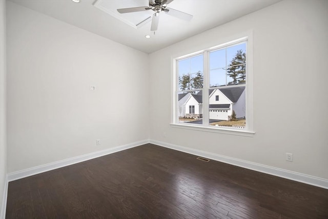 spare room featuring ceiling fan and dark hardwood / wood-style flooring