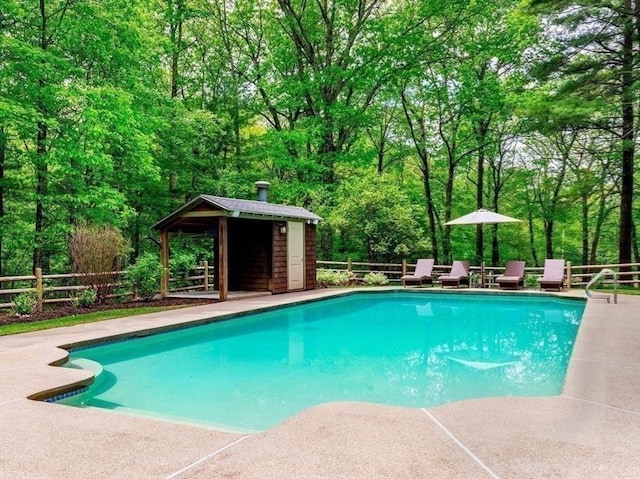 339 N St, Medfield, MA 02052 - view of pool featuring an outbuilding, a patio, and a wooded view