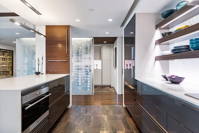 kitchen featuring light countertops, modern cabinets, open shelves, and stainless steel oven
