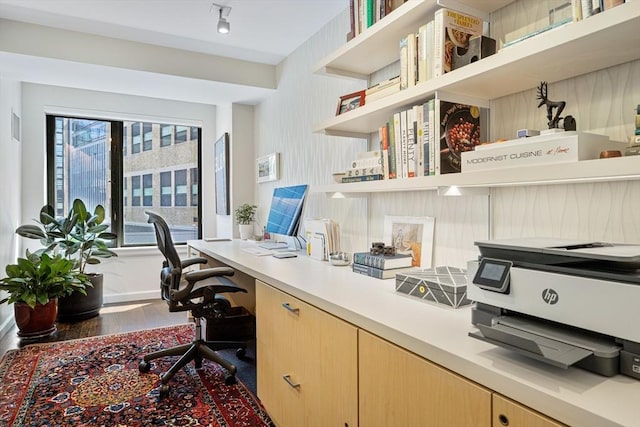 home office with wood finished floors and built in study area